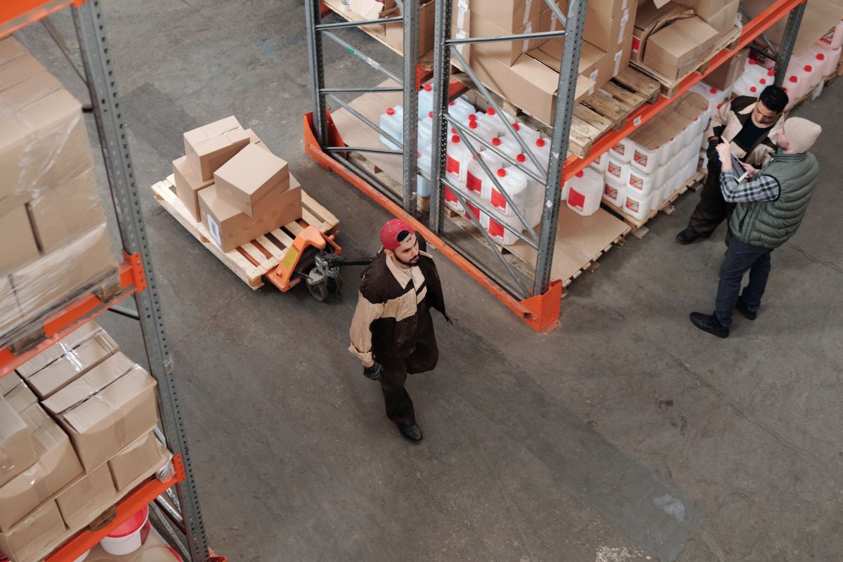 Warehouse team moving pallets of boxed goods